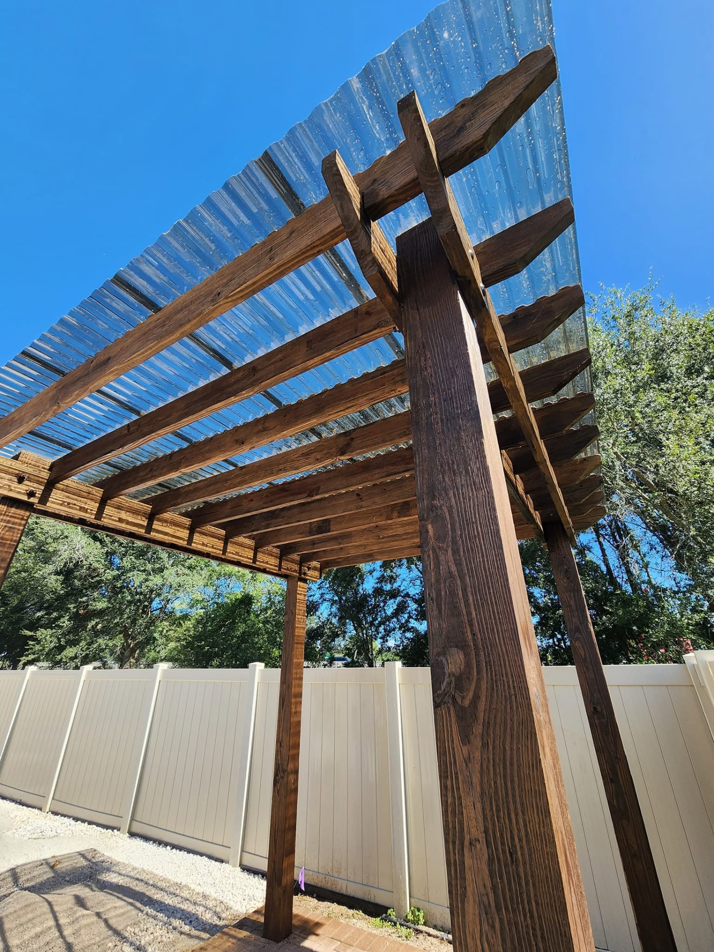 Custom wood pergola with clear roof panels